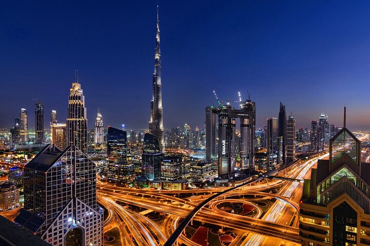 Experience the stunning night skyline of Dubai with shimmering lights reflecting off iconic landmarks like Burj Khalifa and Palm Island creating unforgettable photo opportunities on this panoramic journey.